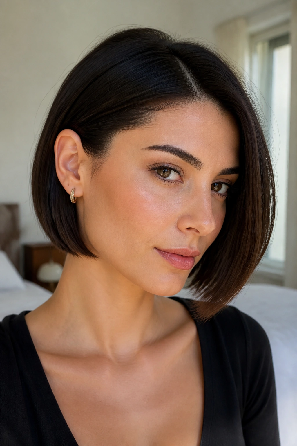 Real woman with an Italian bob tucked behind one ear showing asymmetrical fullness