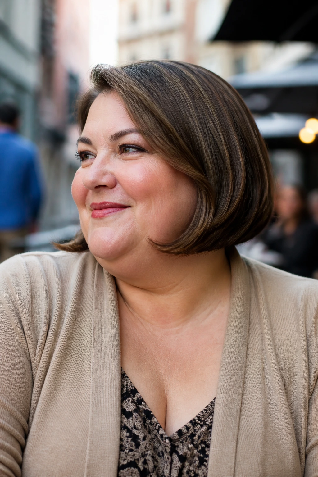 Close-up portrait of a plus-size woman with jaw-skimming bob and flipped ends