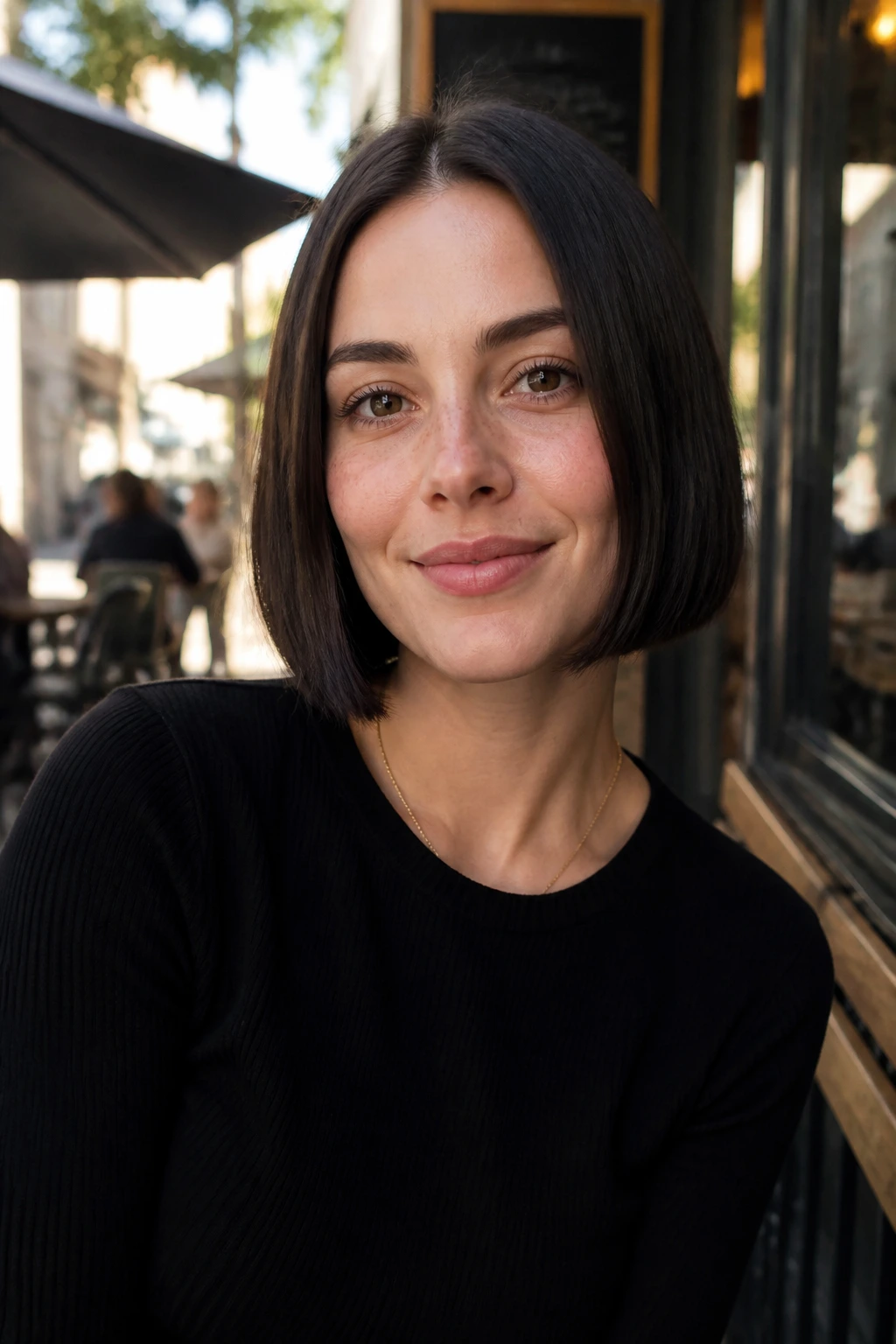 Close-up of a real woman with a jaw-skimming one-length cut in natural daylight