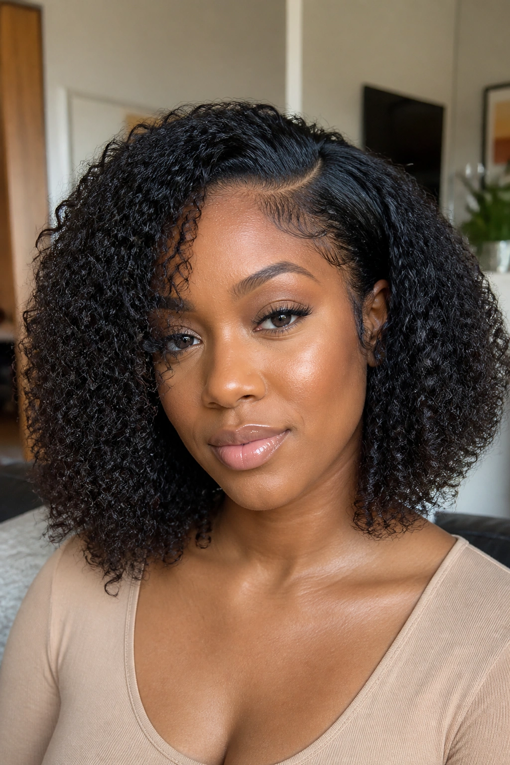 Close-up of a real Black woman with a kinky-curly bob and blended leave-out.