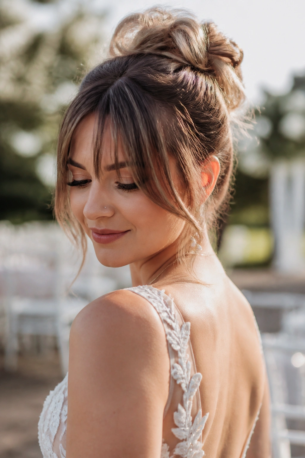 Bride outdoors with messy bun and bottleneck bangs