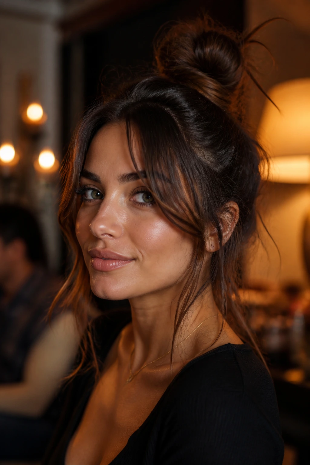 Close-up of a real person with a messy top knot and wispy curtain bangs