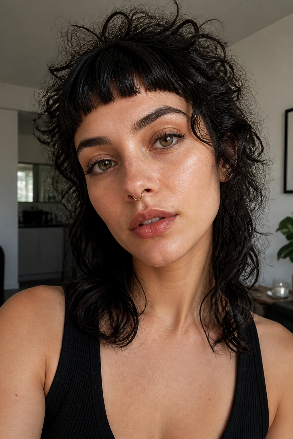 Real woman with micro bangs and fierce fringe in curly wolf shag.