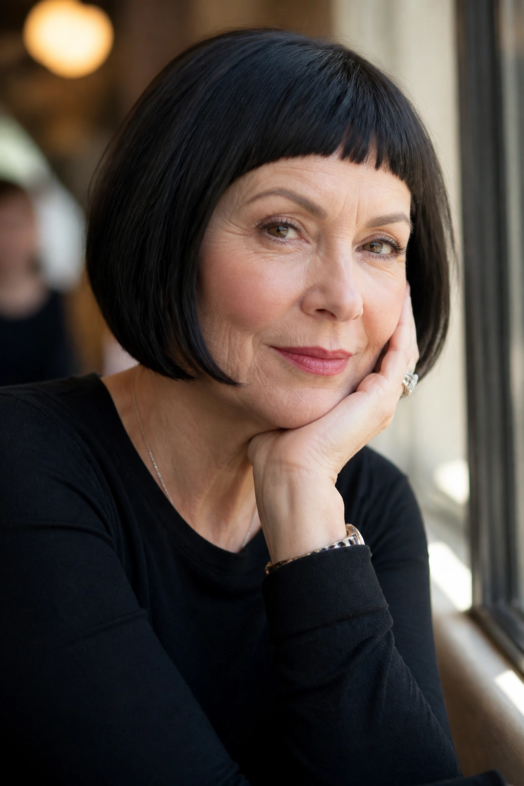 Close-up of a real woman with short micro bangs in soft daylight