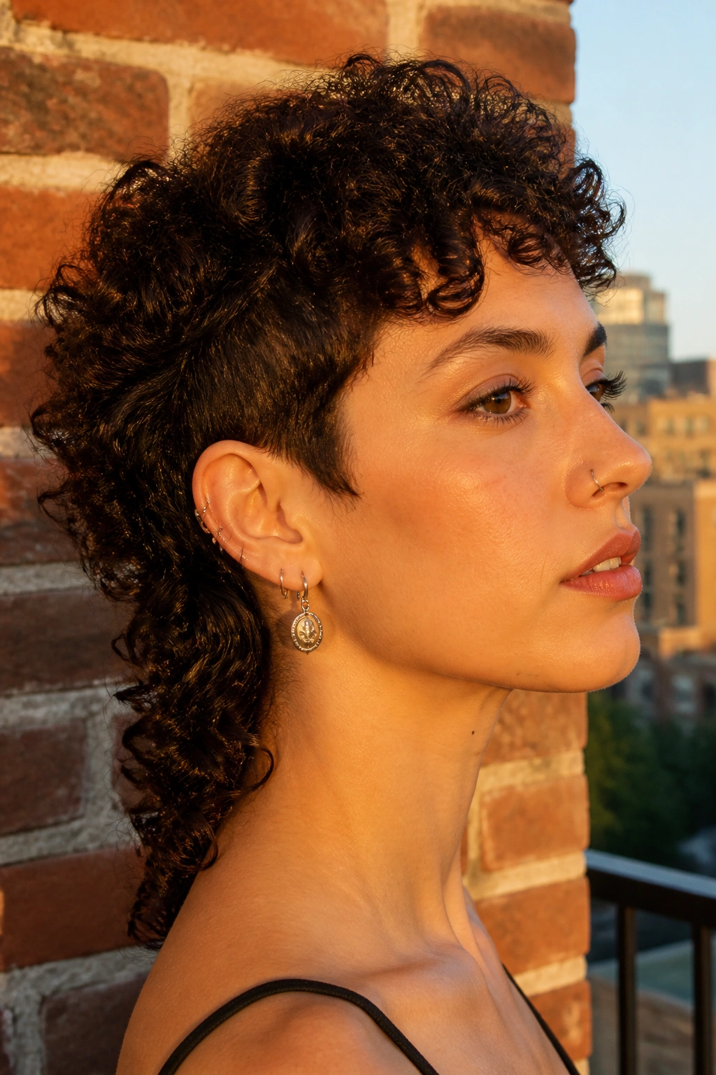 Close-up of a real woman with a micro-mullet wolf cut showing short crown and longer nape.