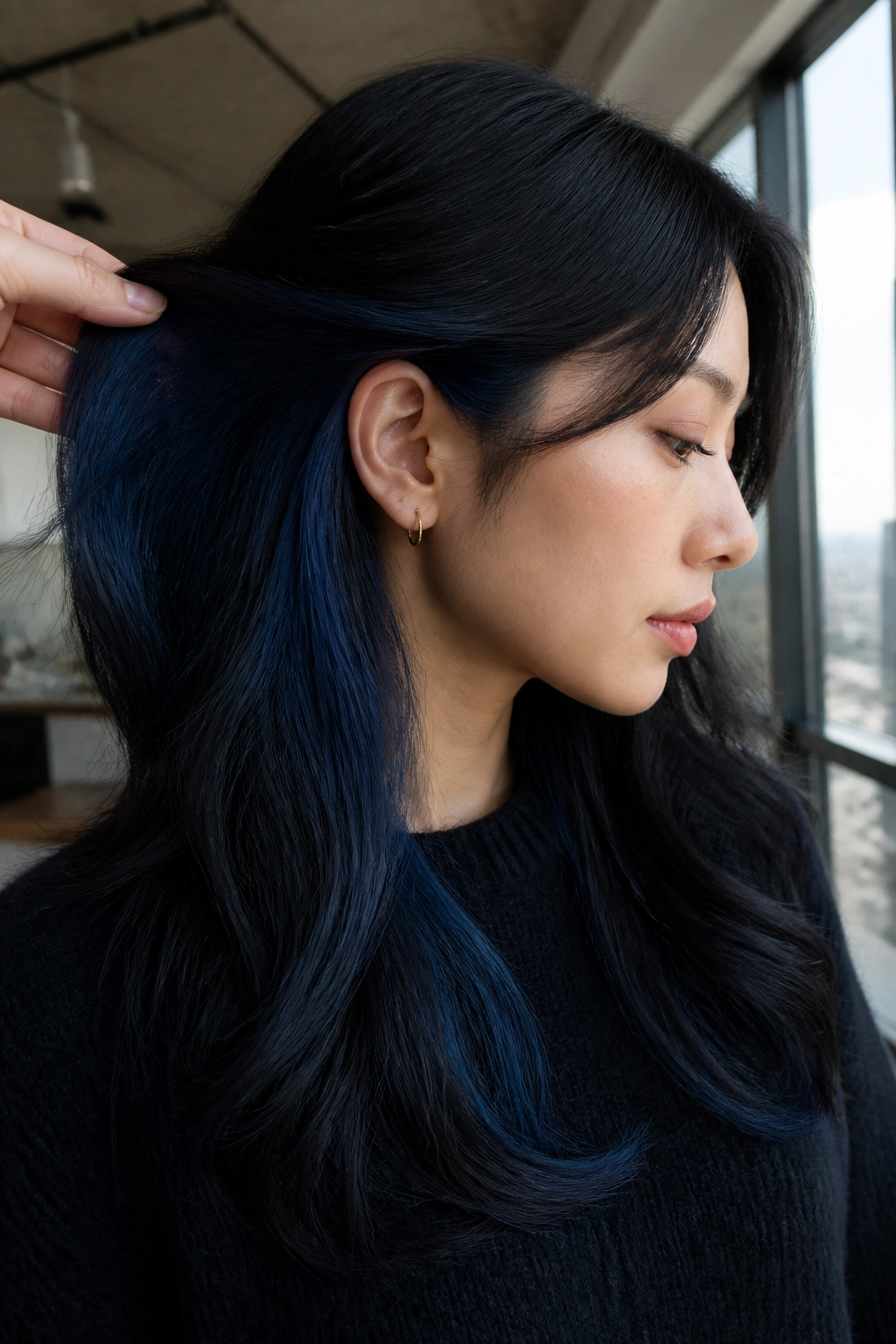 Close-up of a real person with black hair showing midnight blue underlights
