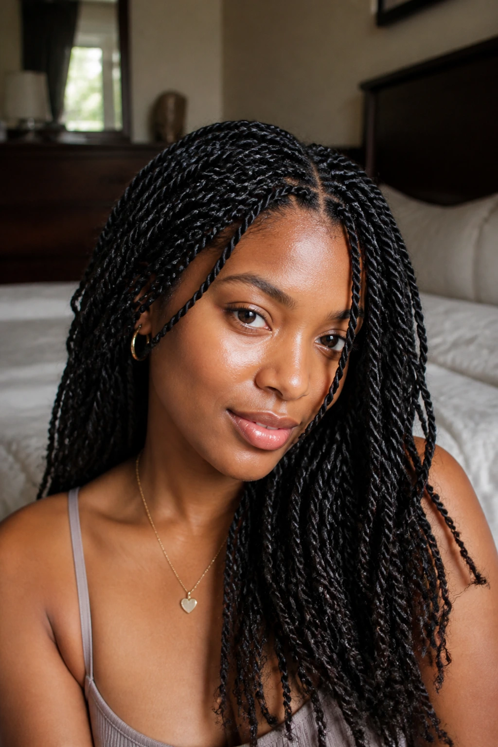 Close-up of tiny twists on real hair in a cozy bedroom