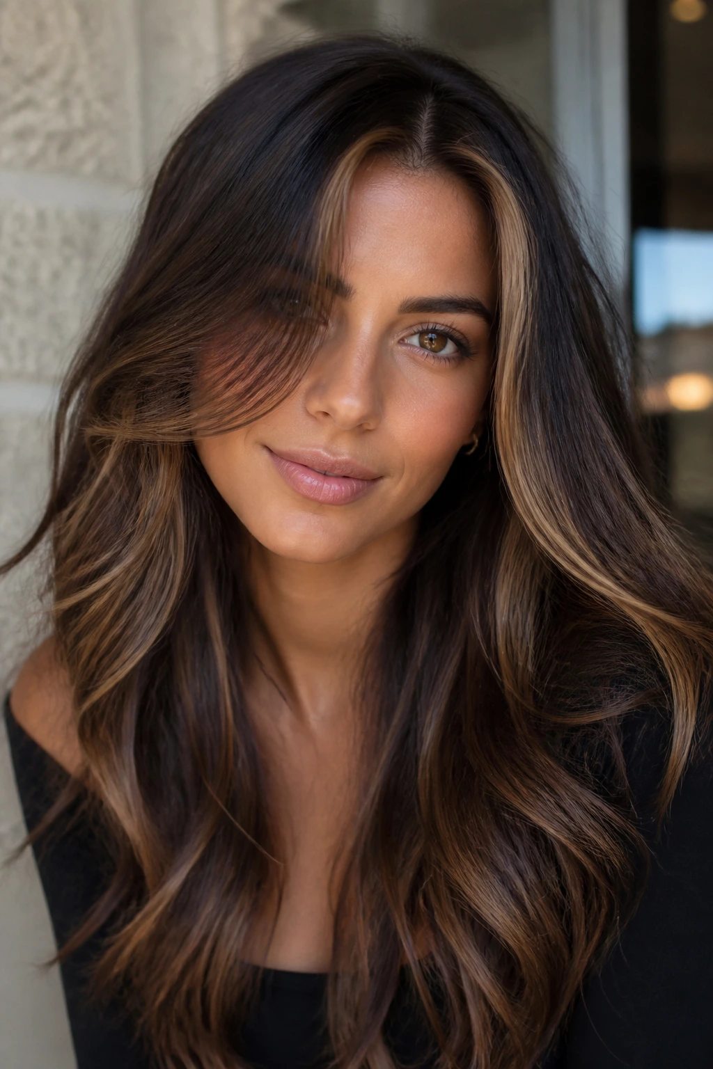 Close-up portrait of a real woman with mocha and toffee highlights on dark brunette hair