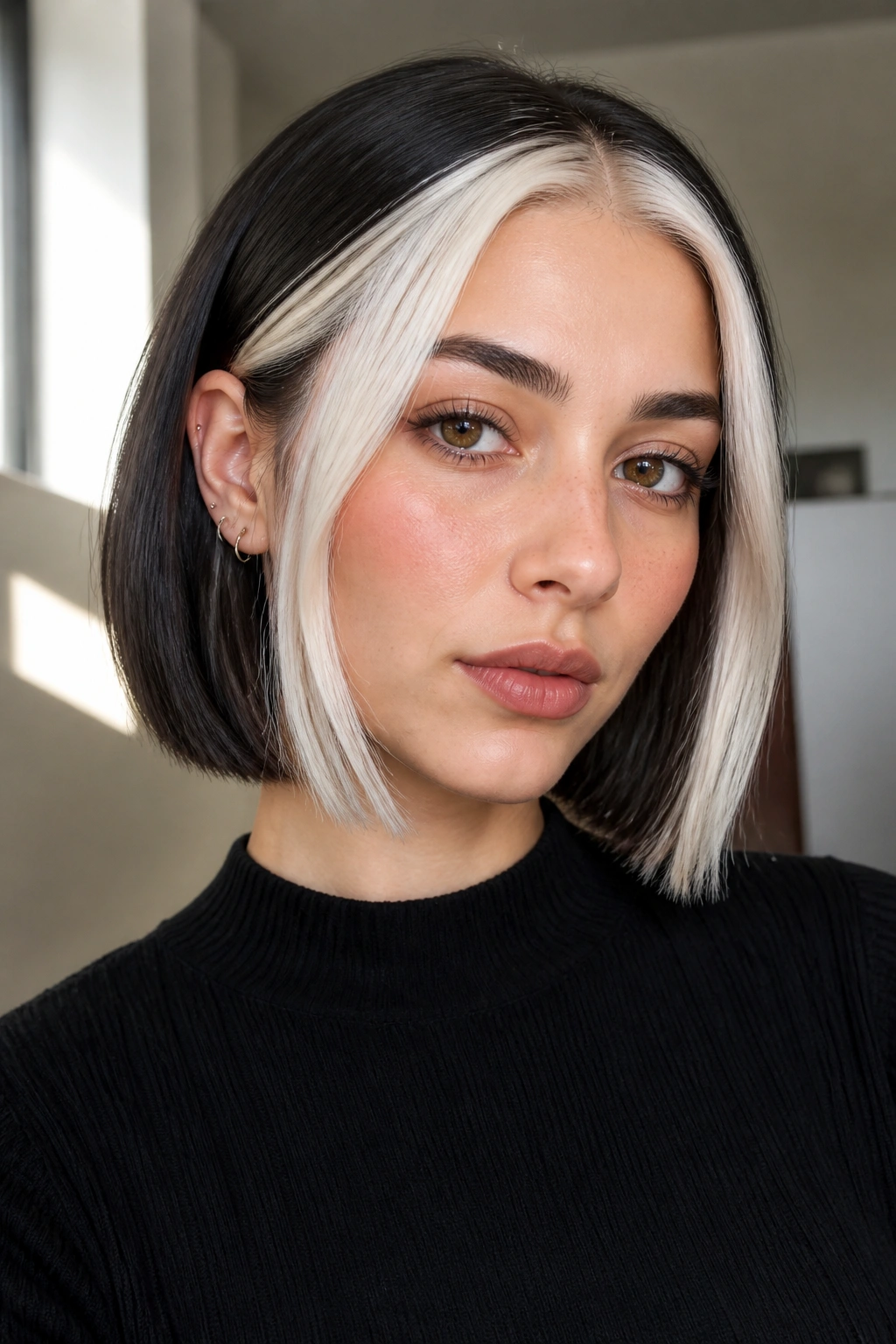 Close-up portrait of a real person with a white money piece contrasted by a dark base hair color.