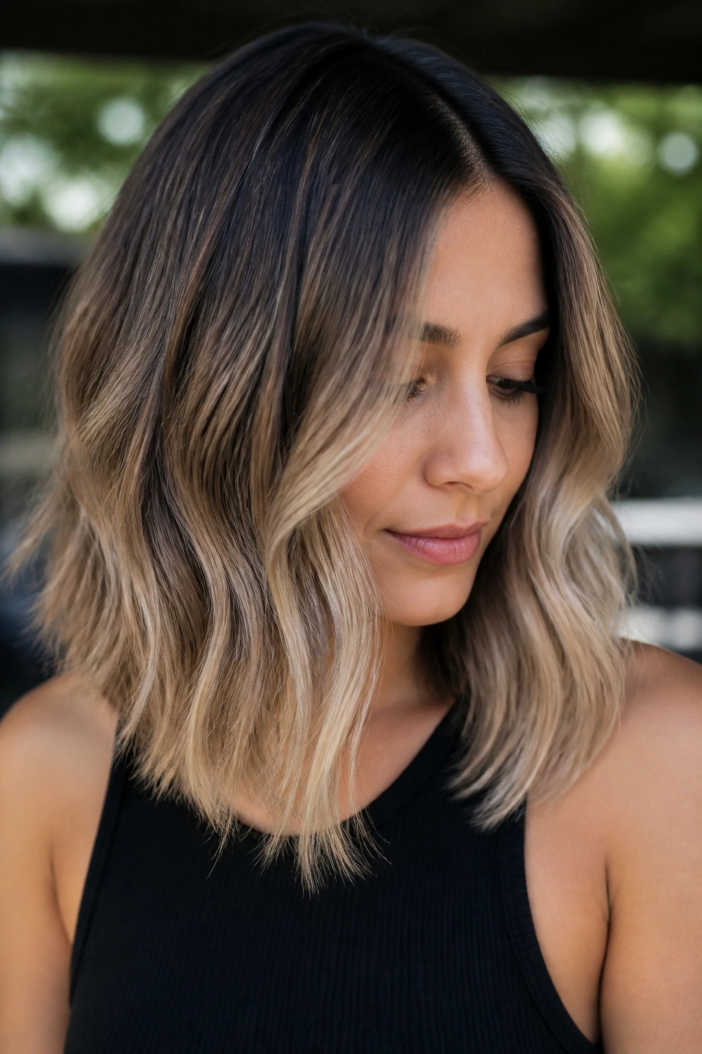 Portrait of a real woman with mushroom brown to beige blonde ombre in a natural outdoor light