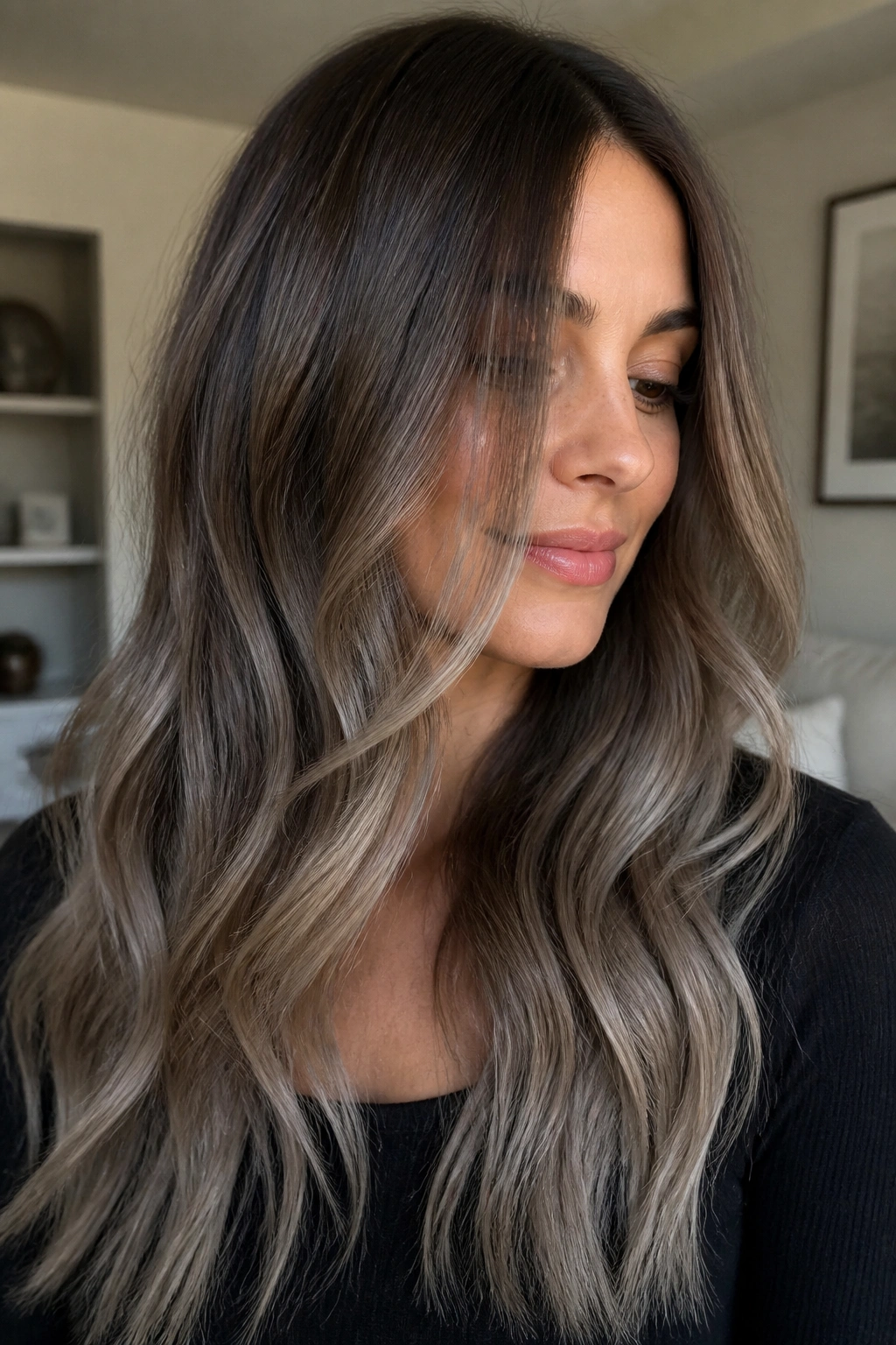 Close-up of a real woman with mushroom brown melt and ashy ends in brunette hair.