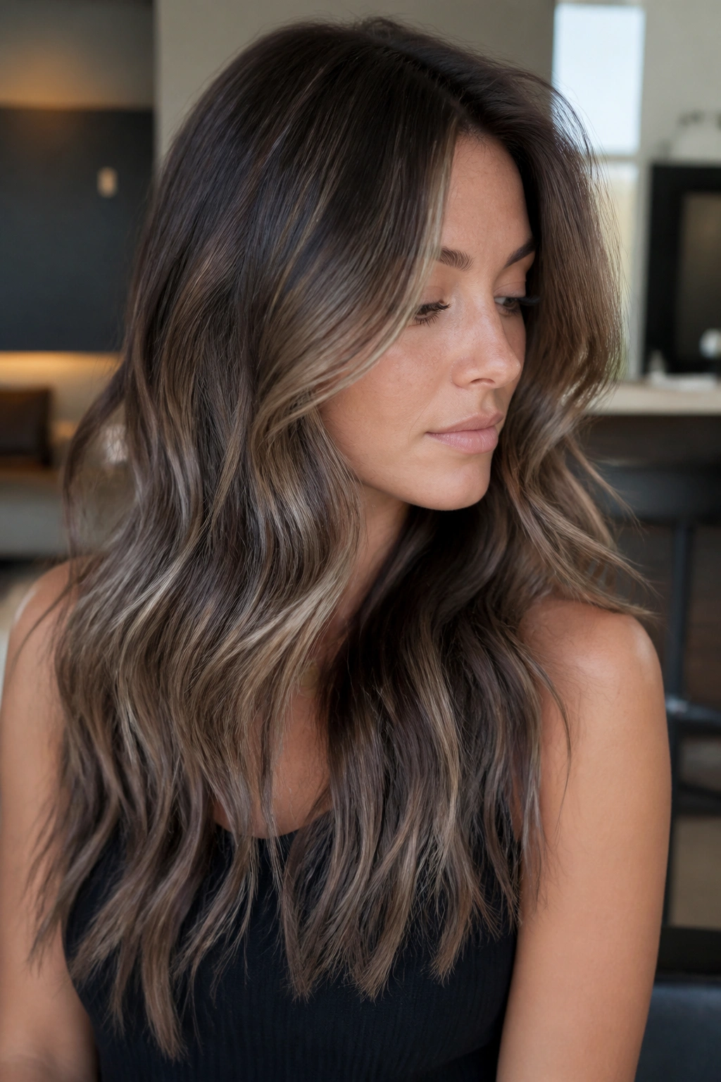 Close-up of brunette with mushroom brown balayage in taupe/beige tones