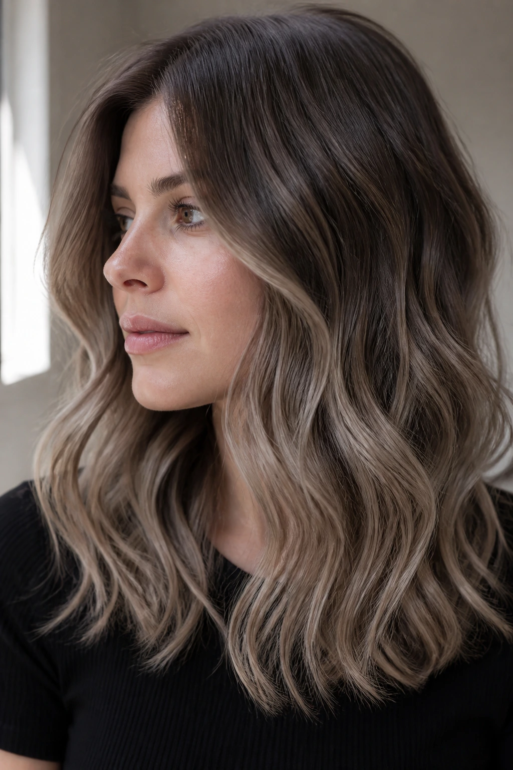 Close-up of mushroom brown hair with cool beige ends on a real person