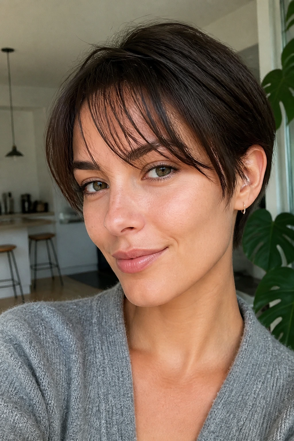 Close-up of a woman with forward-styled wispy front sections, no bangs.