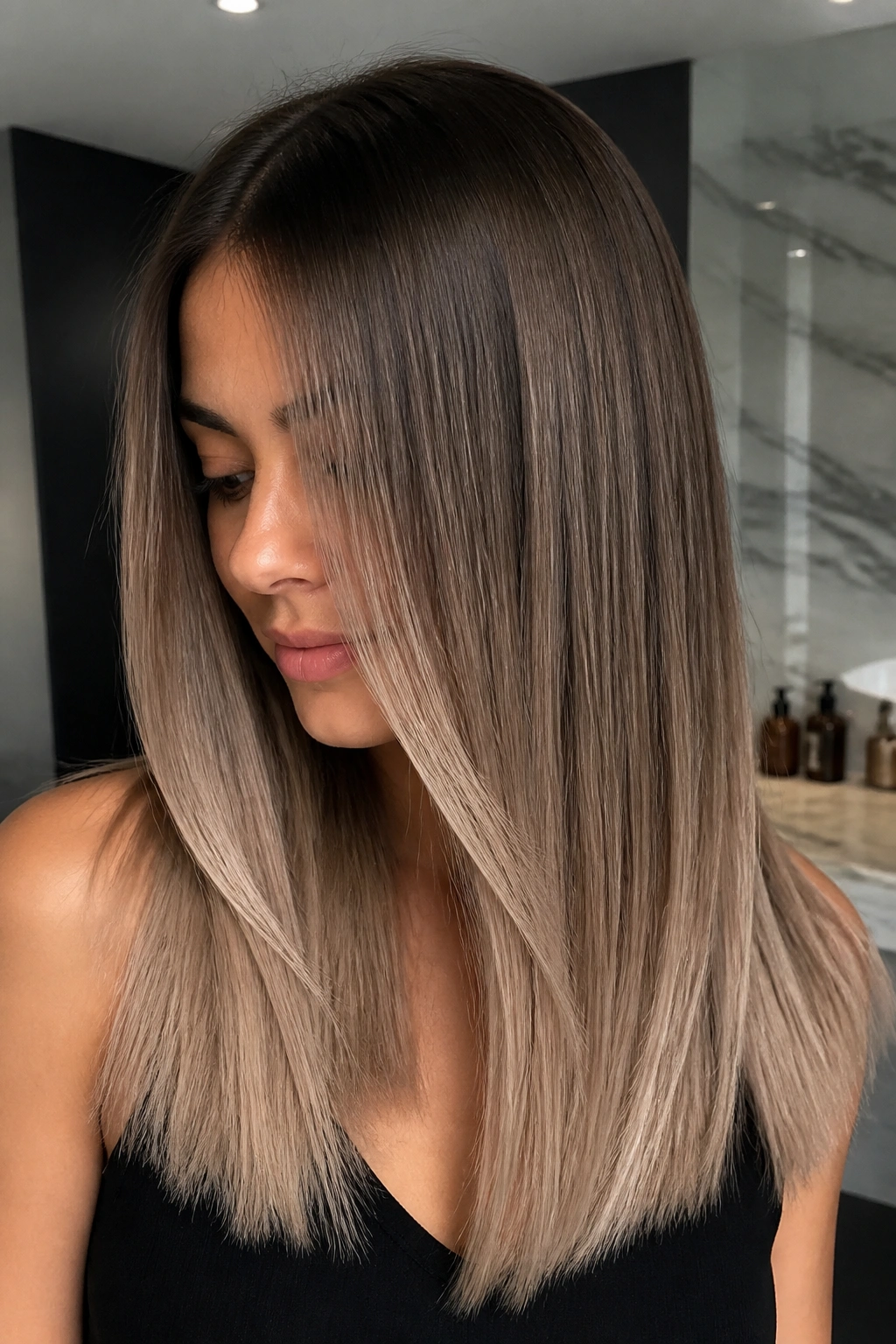Close-up of a real woman with Olive Brown to Smoky Beige Melt on straight hair.