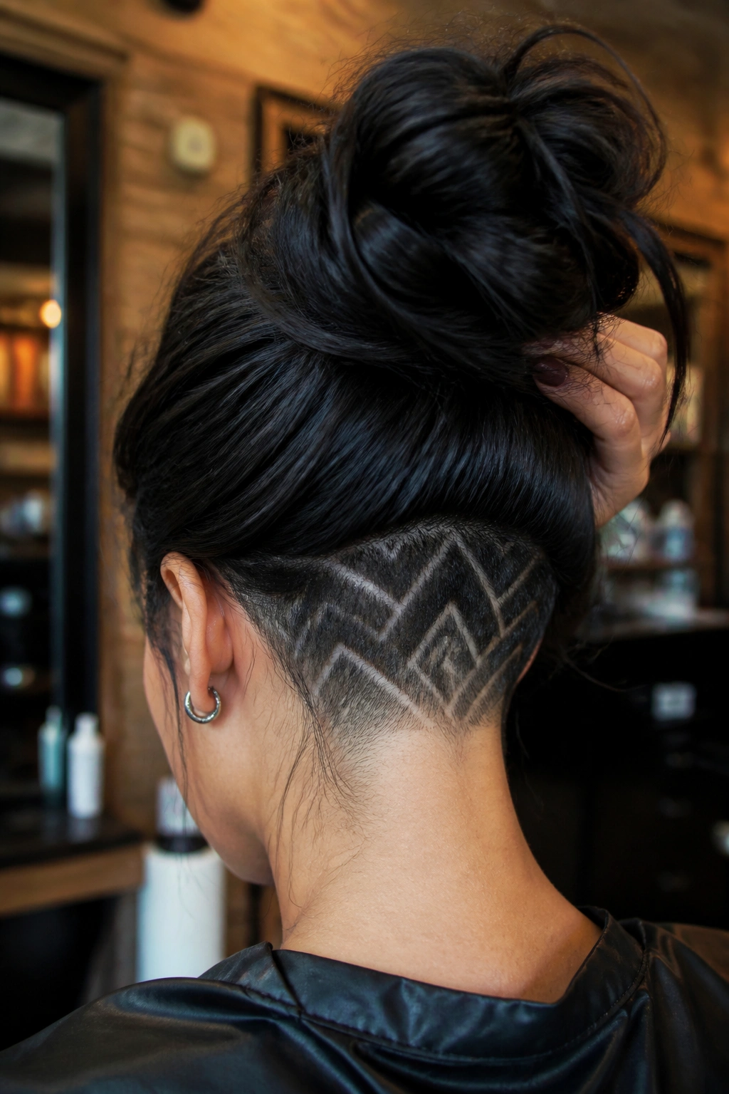 Back view of real person showing patterned undercut at the nape with bold finish.