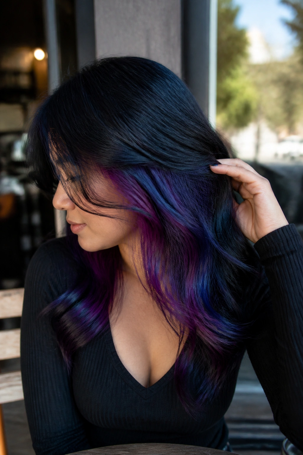 Close-up of blue-black hair with plum and indigo peekaboo panels under the top layers.