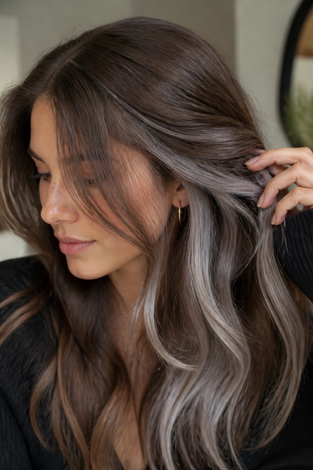 Real person showing peekaboo silver panels under the top layer of medium brown hair.