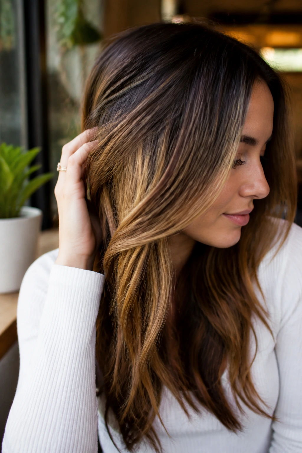 Close-up portrait showing under-layer peekaboo panels on layered hair