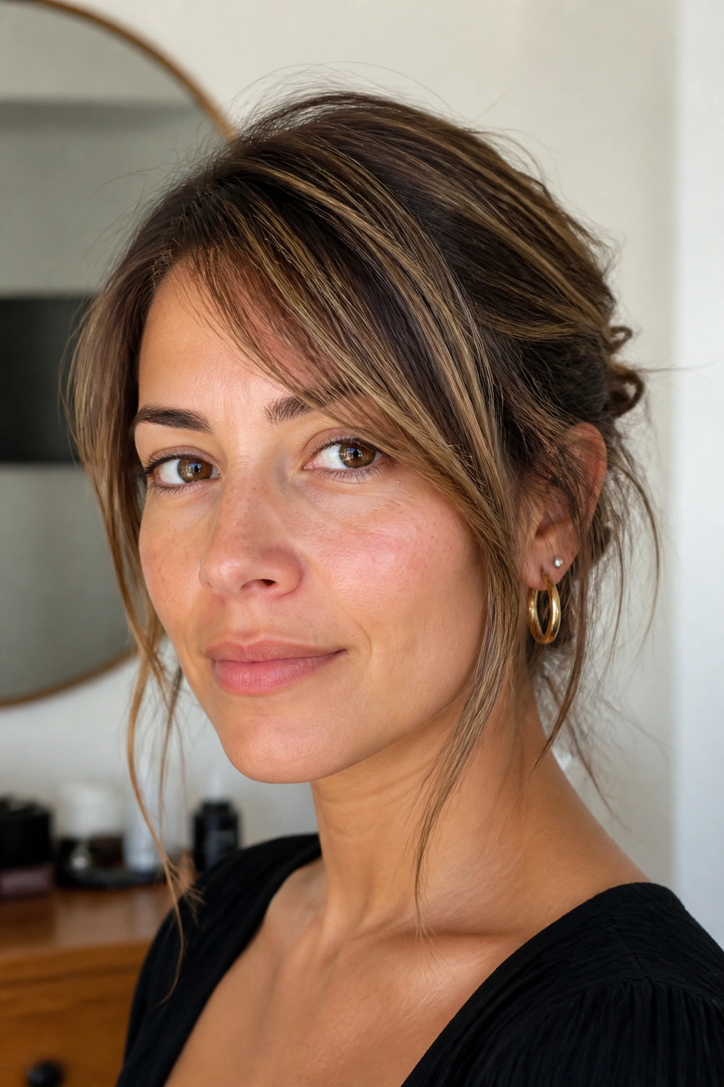 Close-up of a woman with a low-maintenance piecey side sweep