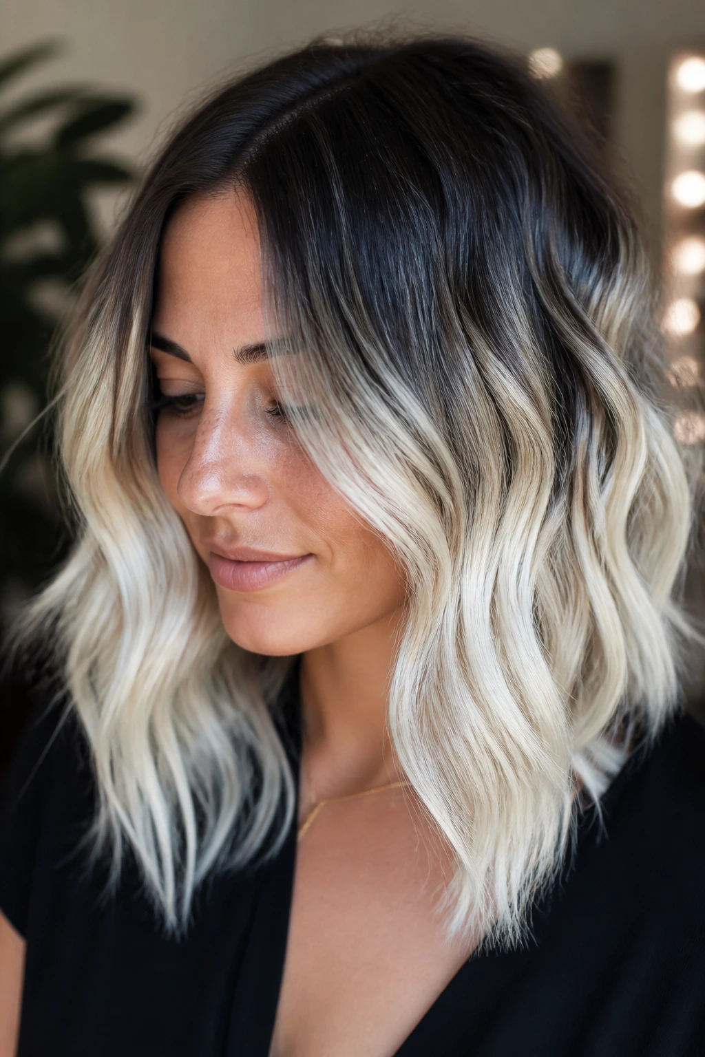 Close-up of a real woman with platinum blonde ends and dark roots on wavy hair