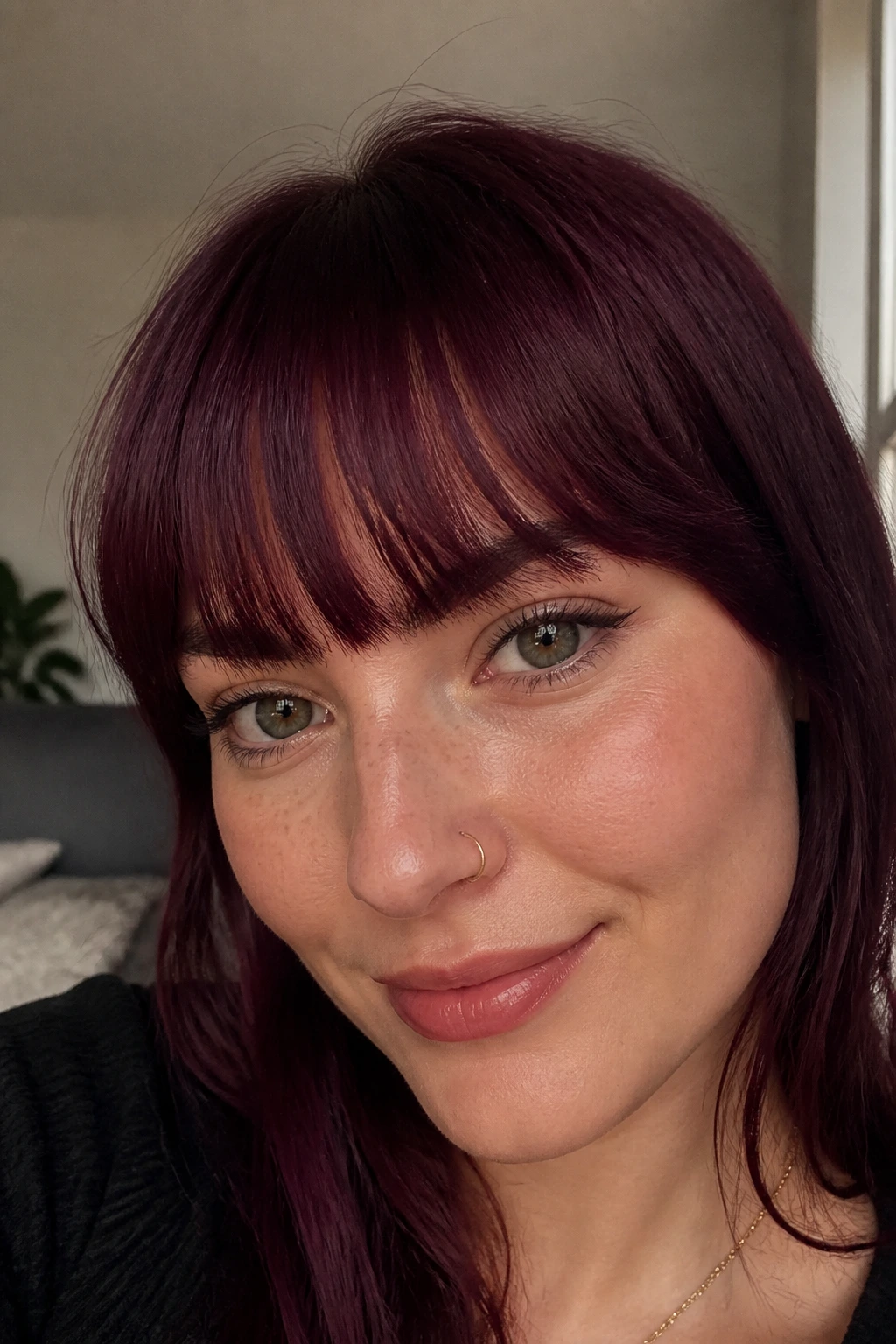 Close-up of a real woman's plum wine fringe with soft window light