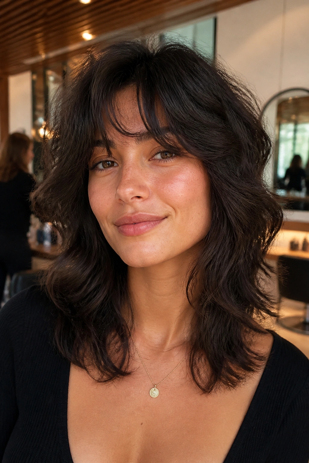 Close-up of a real woman with a razored wolf cut in a bright salon