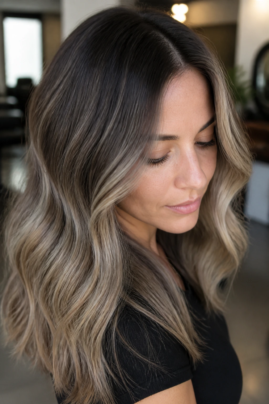 Close-up of real woman with root-melted ash hair showing seamless gradient from roots to highlights