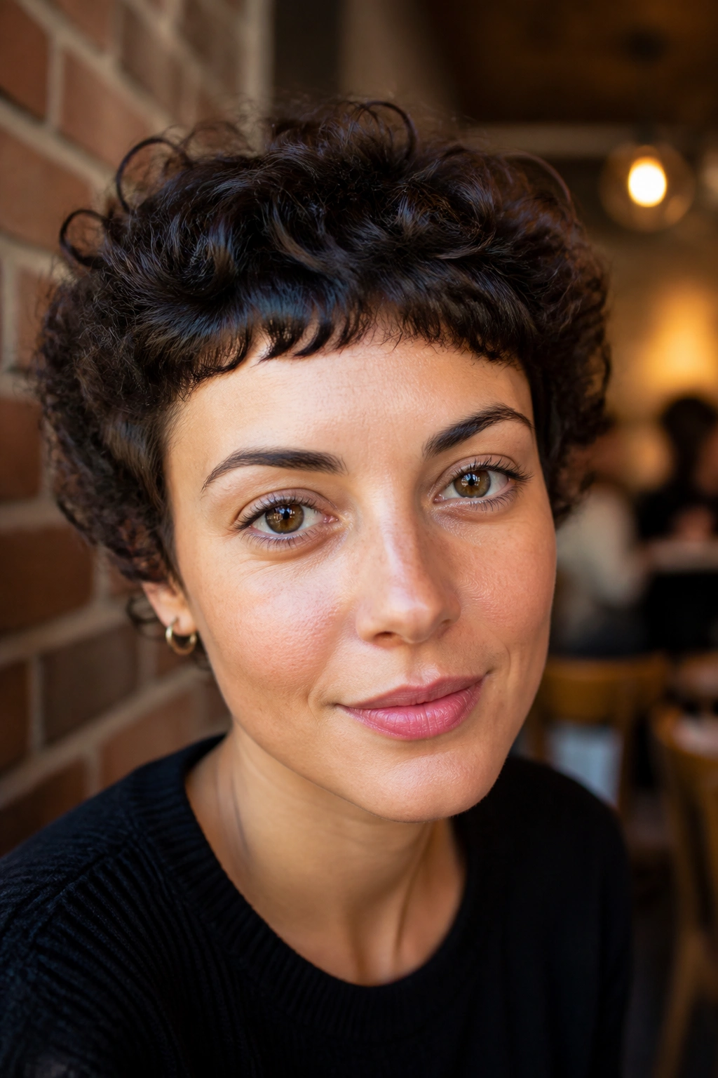 Close-up portrait of a real woman with Rounded Crop With Micro Fringe showing tiny fringe above brows