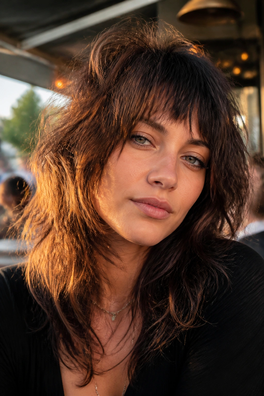 Close-up of real woman with shag haircut and choppy bangs on a sunny street.
