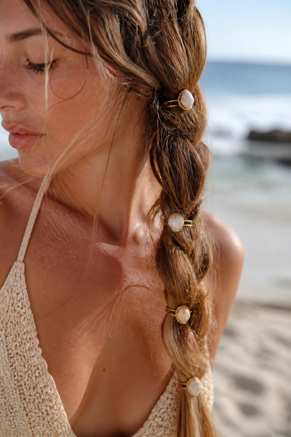 Real person wearing shell-detail hair rings in a beachy boho braid.