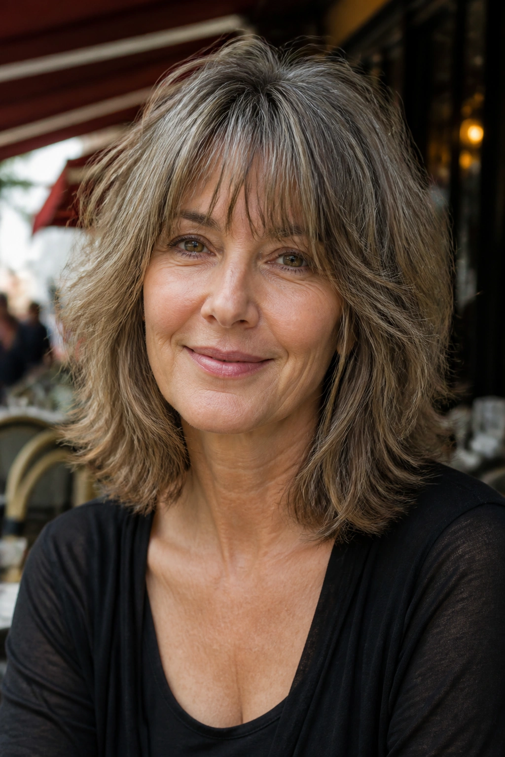 Portrait of a real woman with a shoulder-length shag hairstyle.