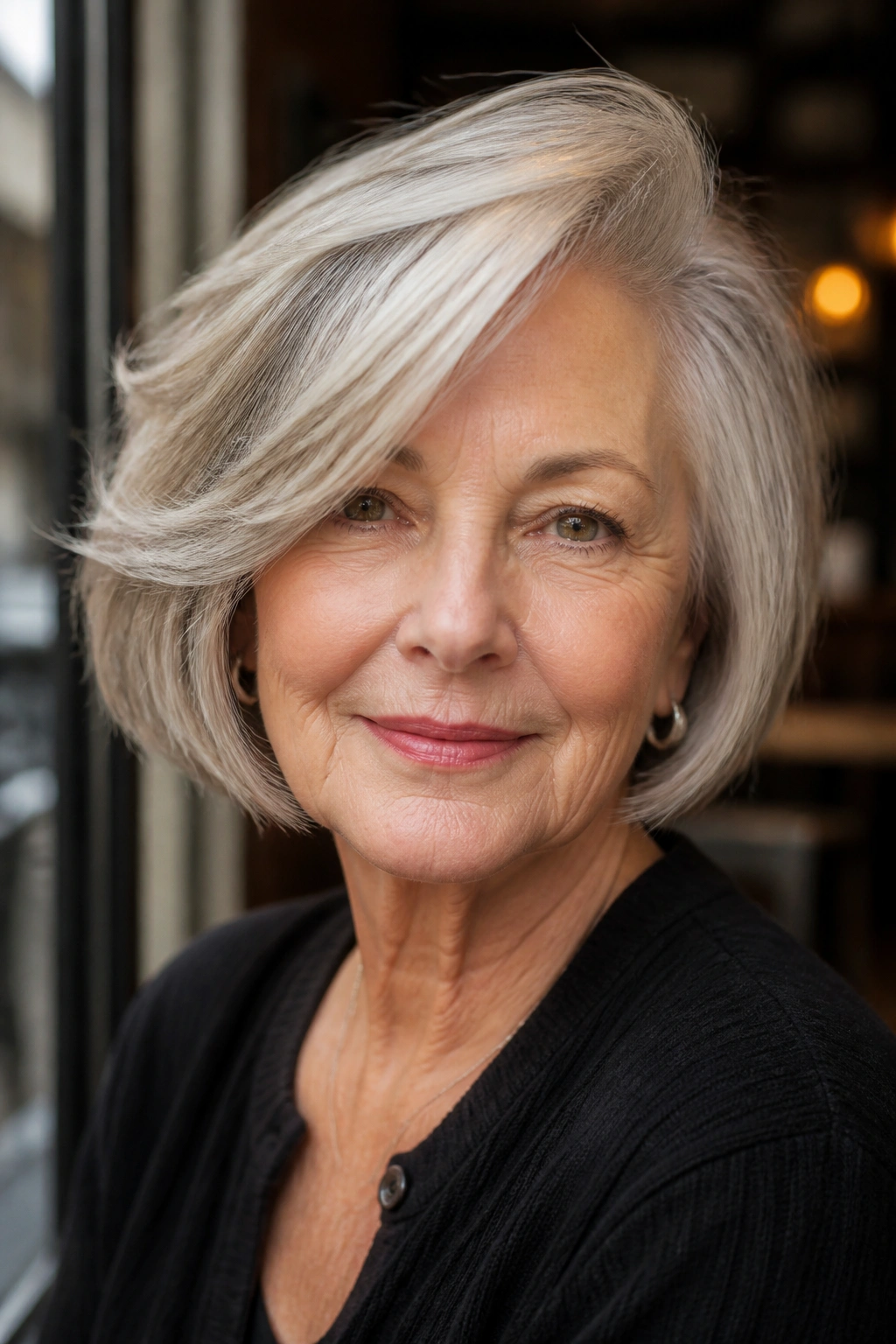 Close-up portrait of a real woman with side-swept bob and temple volume.