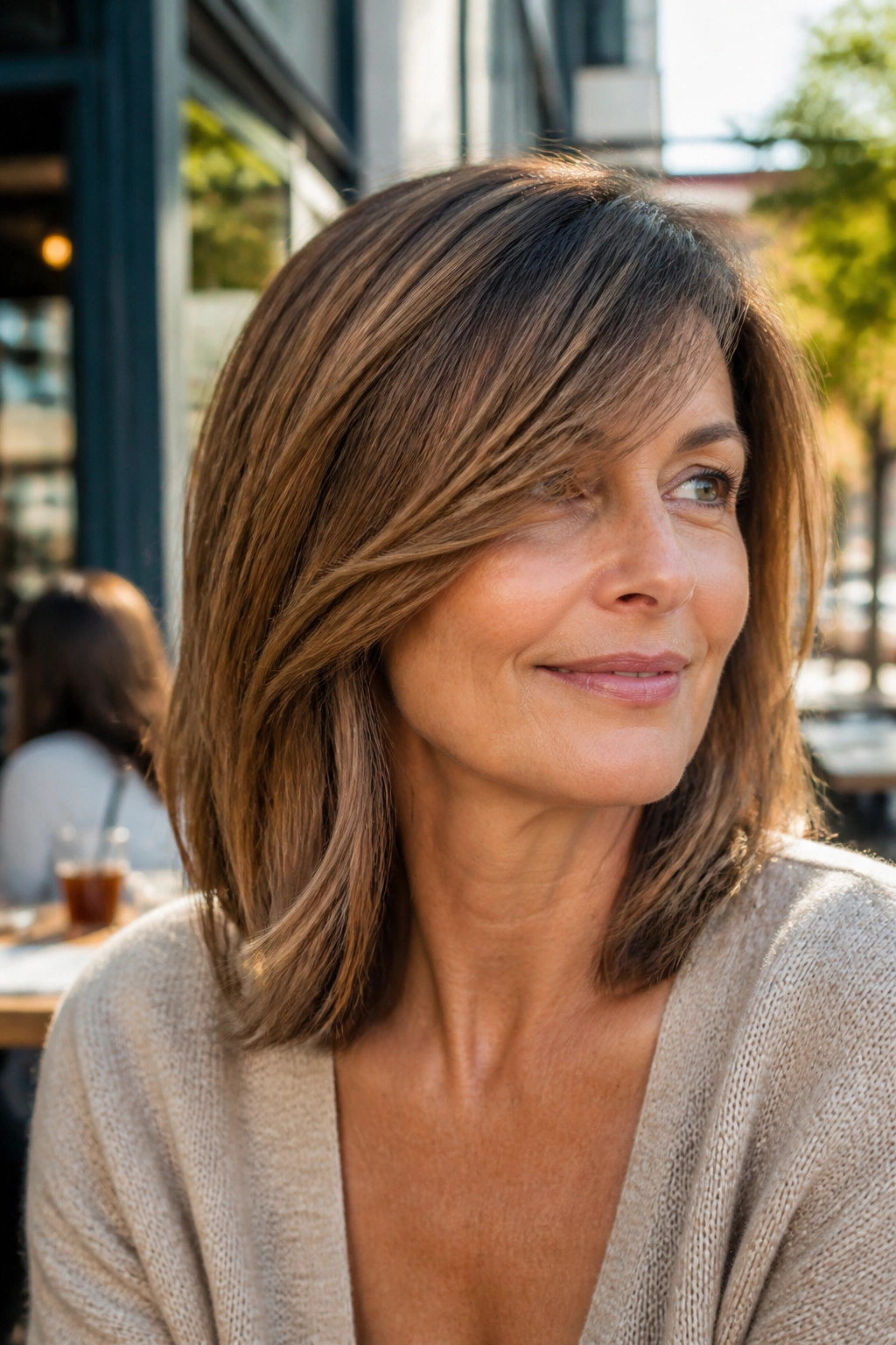Close-up of a woman with deep side-swept fringe and shoulder-length hair