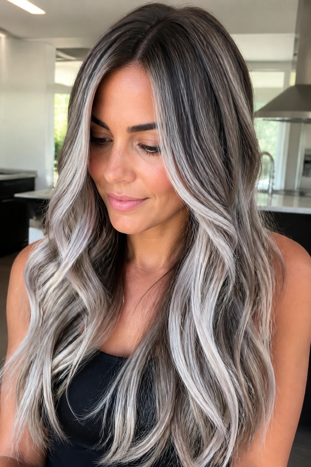 Close-up portrait of a real woman with long hair featuring icy silver ash highlights