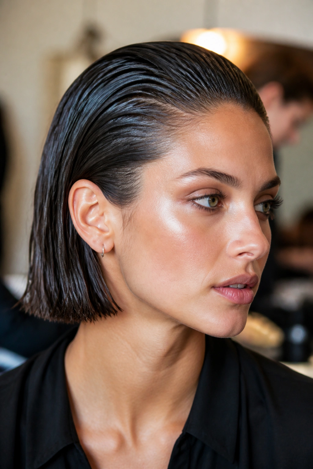 Portrait of a real woman with a sleek, glossy wet-look bob