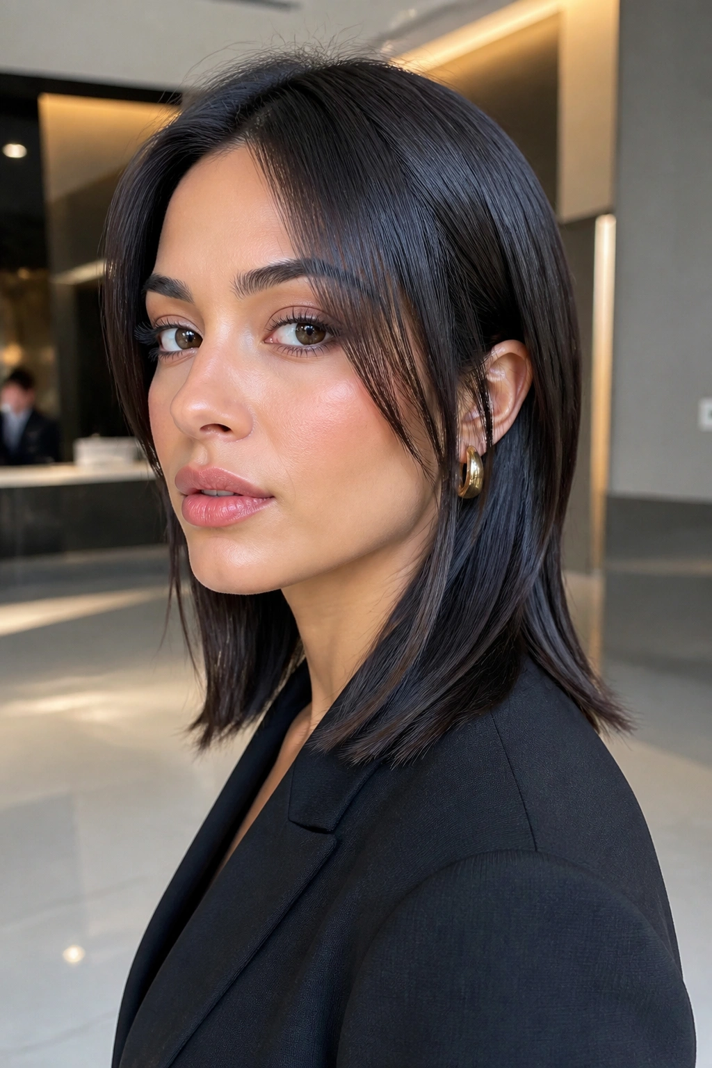 Close-up of a real woman with a sleek wolf cut and hidden layers.