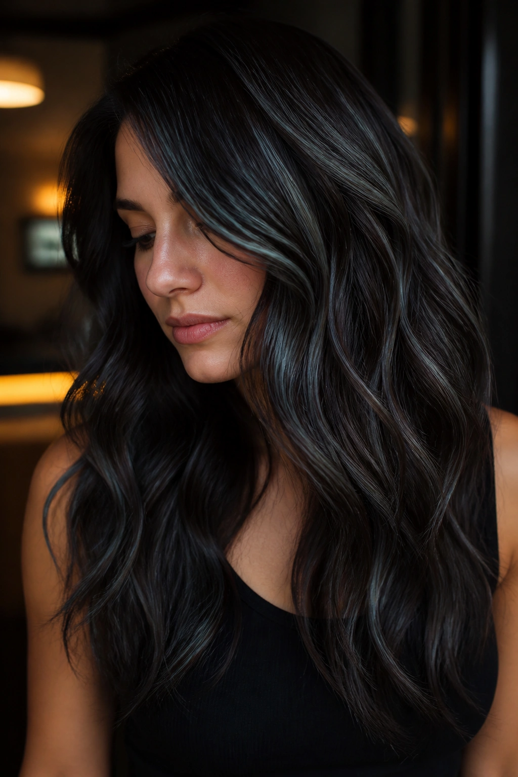 Close-up of a real woman with charcoal ribbons in dark brunette hair