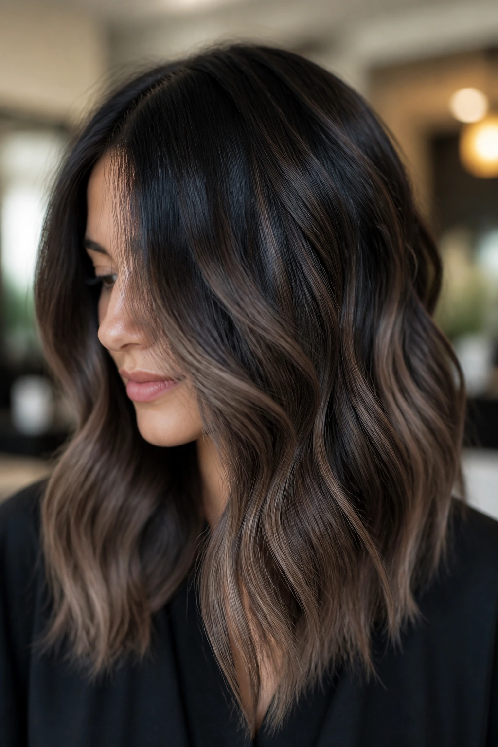 Portrait of a person with smoky ash balayage on dark hair