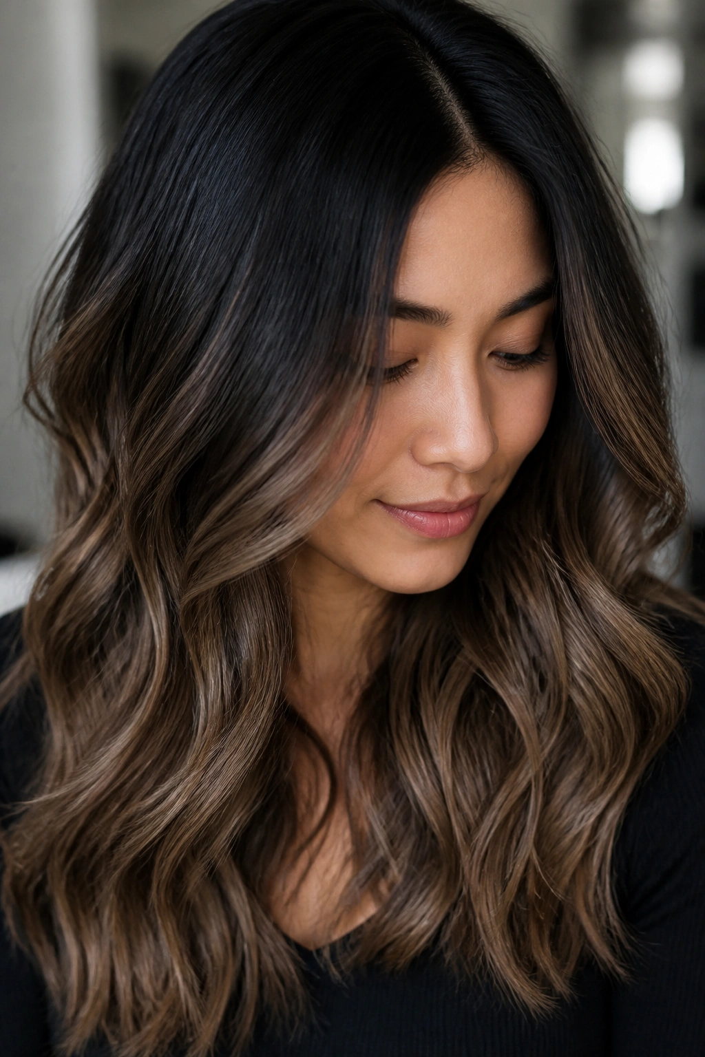 Close-up portrait of a real woman showing soft black to mocha brown ombre with smooth transition