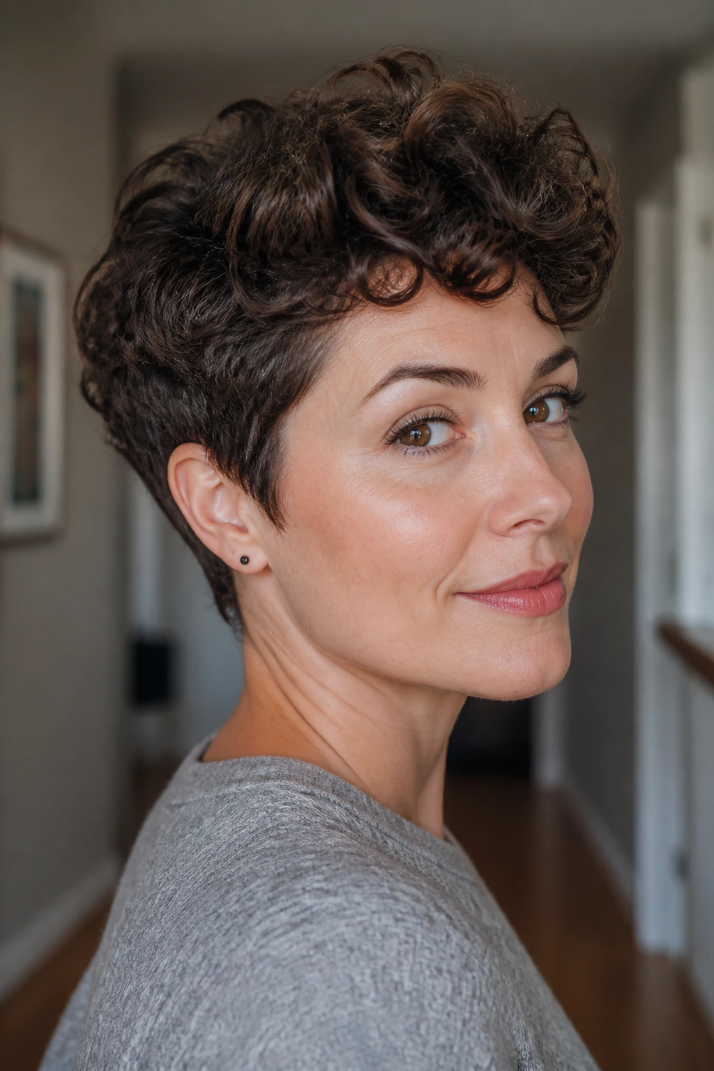 Portrait of a real person with soft curly pixie and long top, head-and-shoulders shot