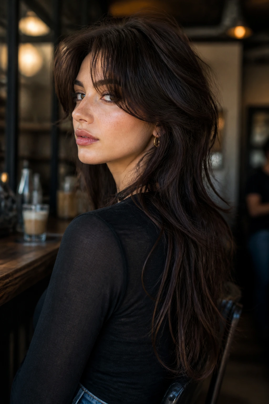 Three-quarter portrait of a woman with soft mullet for long hair.