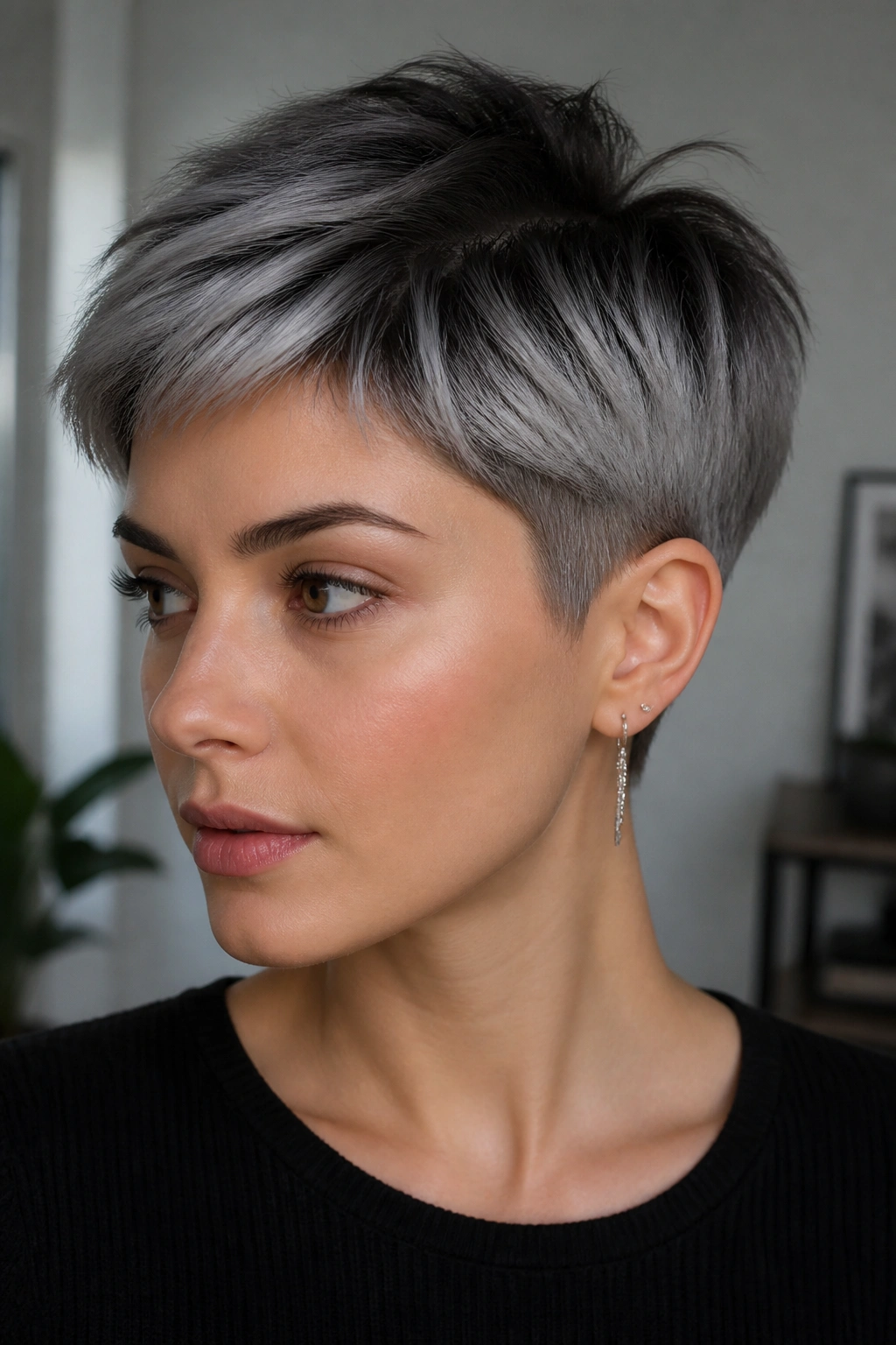 Close-up portrait of a real person with steel gray ombre on a short crop.