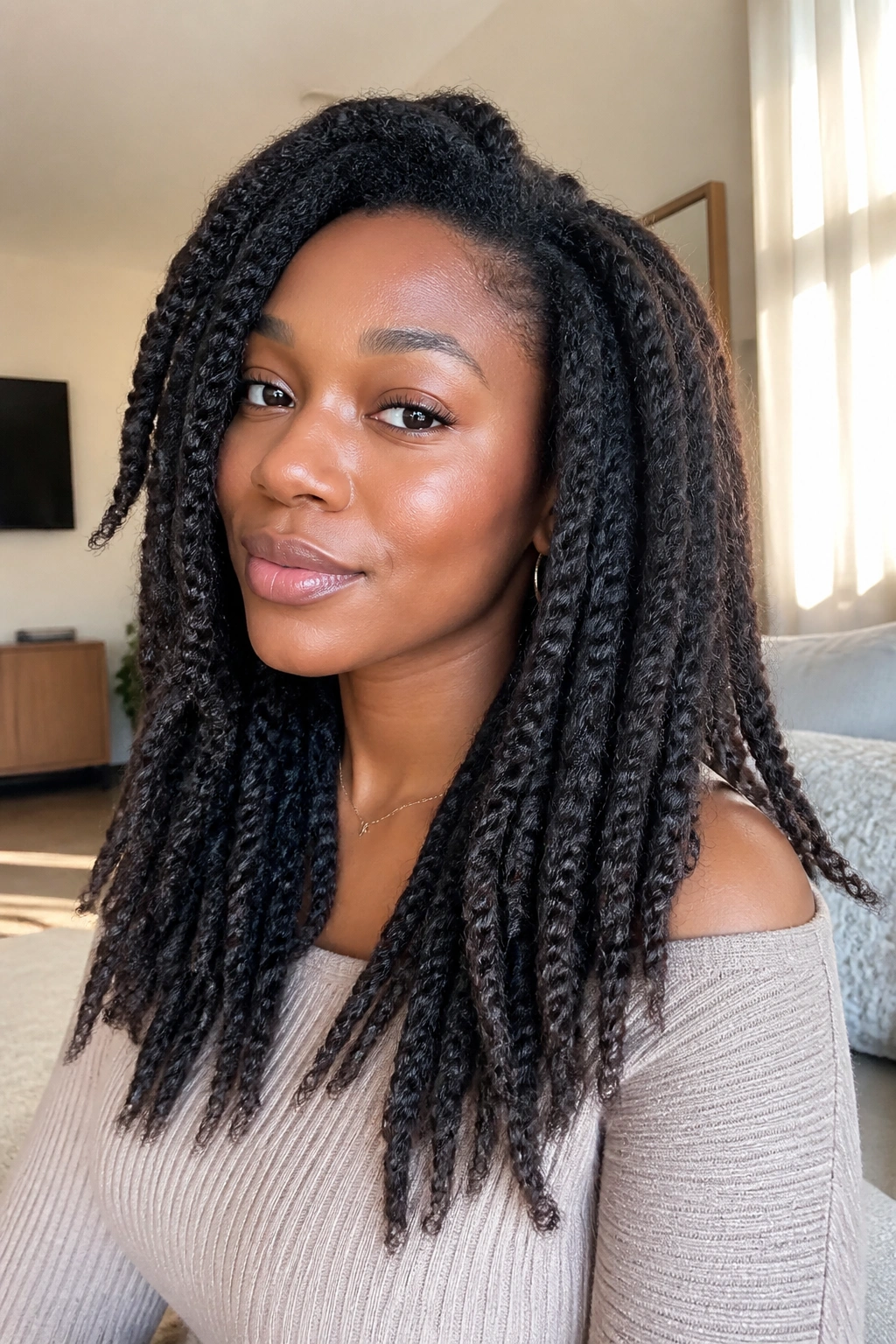 Close-up of a real person with stretched twist-out hairstyle showing rope-like twists and length
