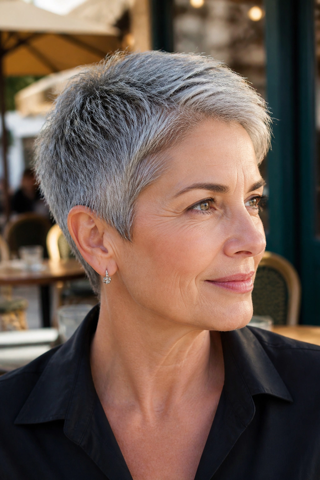 Portrait of a real woman with a tapered salt-and-pepper crop in outdoor daylight