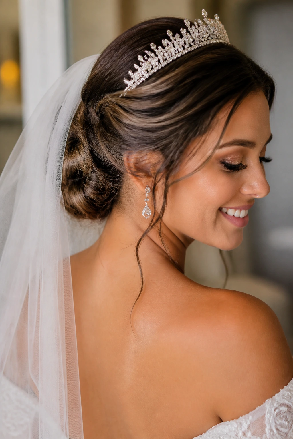 Close-up of a bride with a textured low twist and veil-friendly tiara
