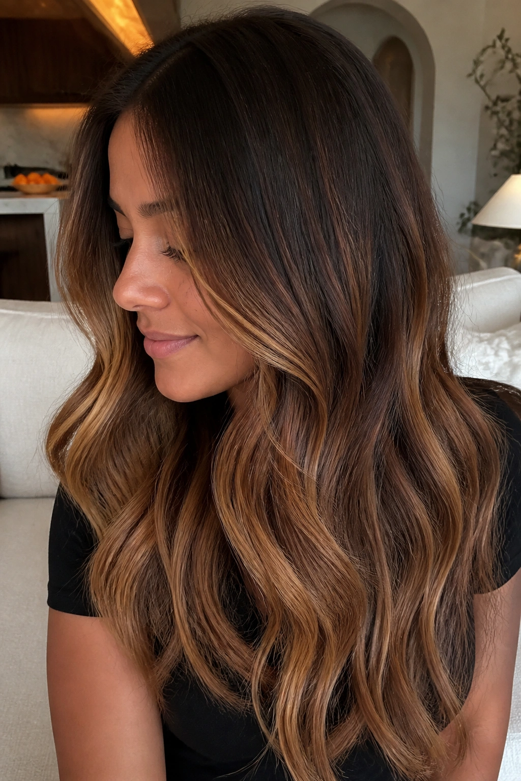 Medium-close portrait of brown hair with toffee balayage from mid-lengths to ends