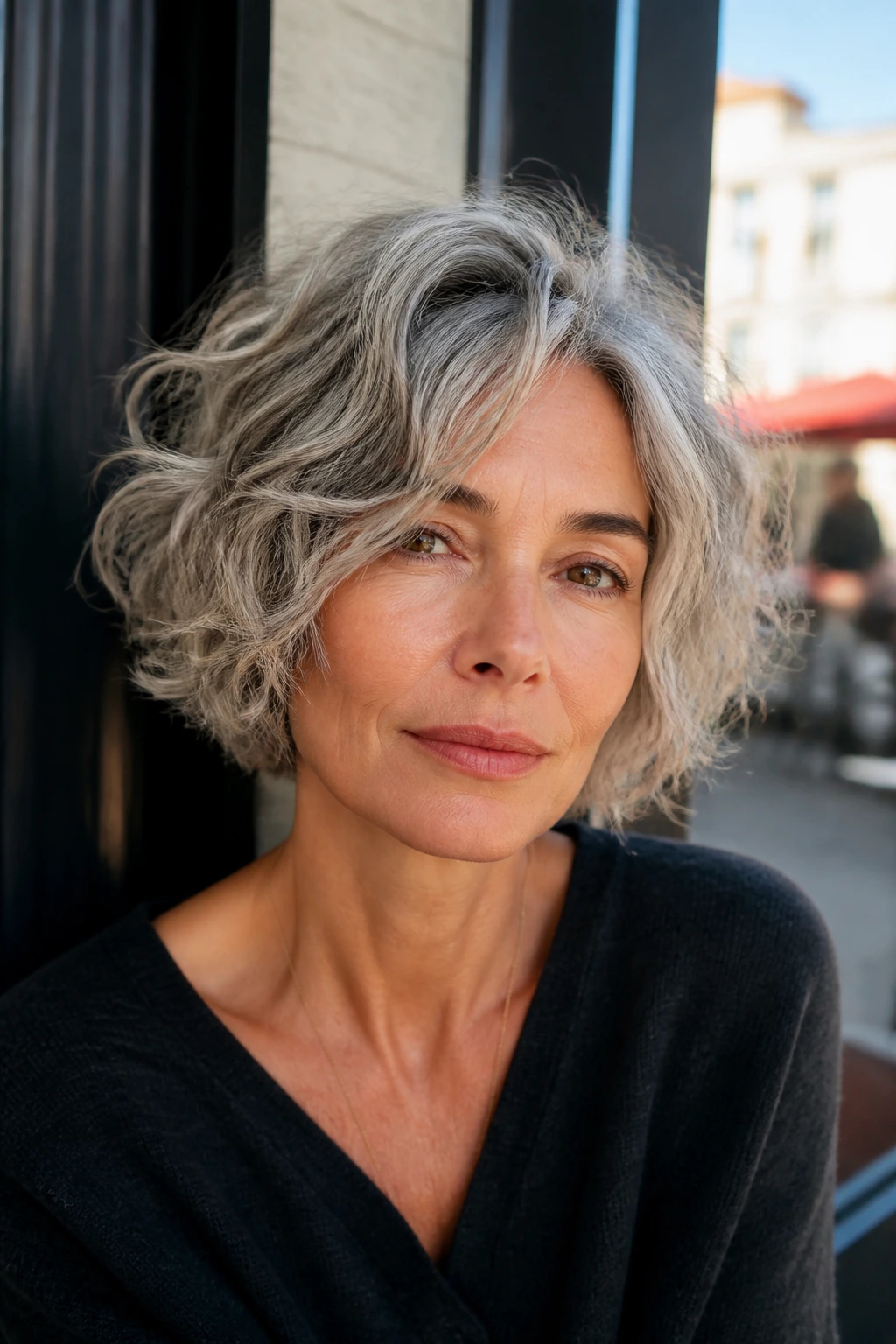 Close-up of a woman with tousled gray bob and air-dried waves.
