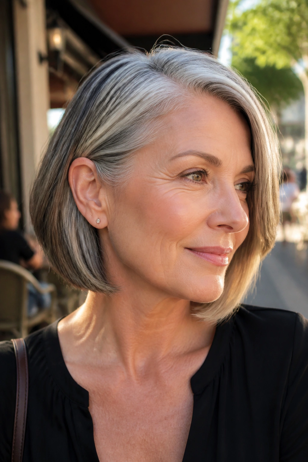 Real woman with bob tucked behind the ear highlighting cheekbone and color blend