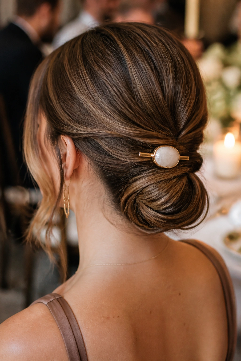 Close-up of a real woman with a twisted low knot and a statement barrette